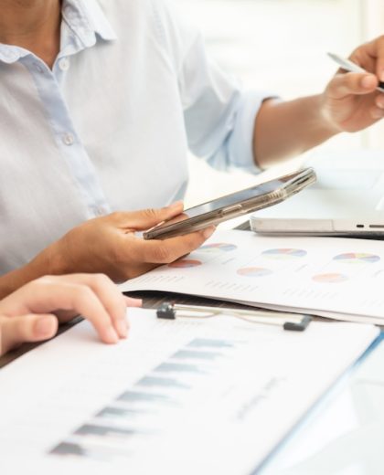 teamwork process. business people discussing the charts and graphs showing the results of their successful cooperation,  analyze financial report for business plan, selective focus.